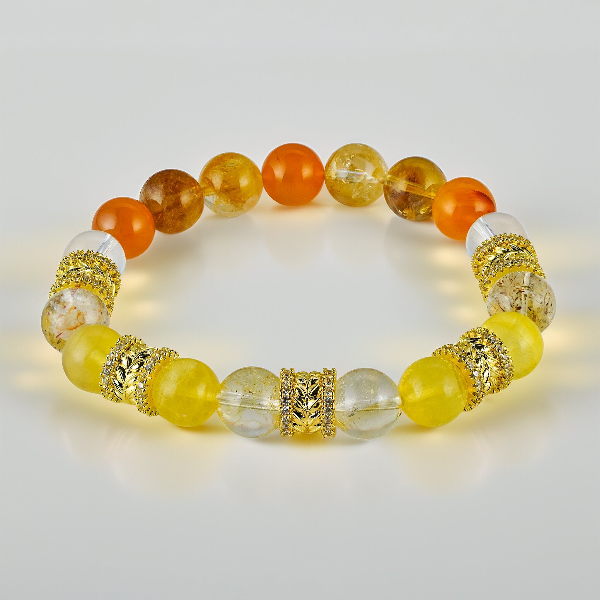 Golden Wreaths The Dawn Halo bracelet by XOIAX featuring Orange Carnelian, Yellow Phantom Quartz, and Rutilated Quartz beads with 18k gold plated accents, a feng shui bracelet for bold vision