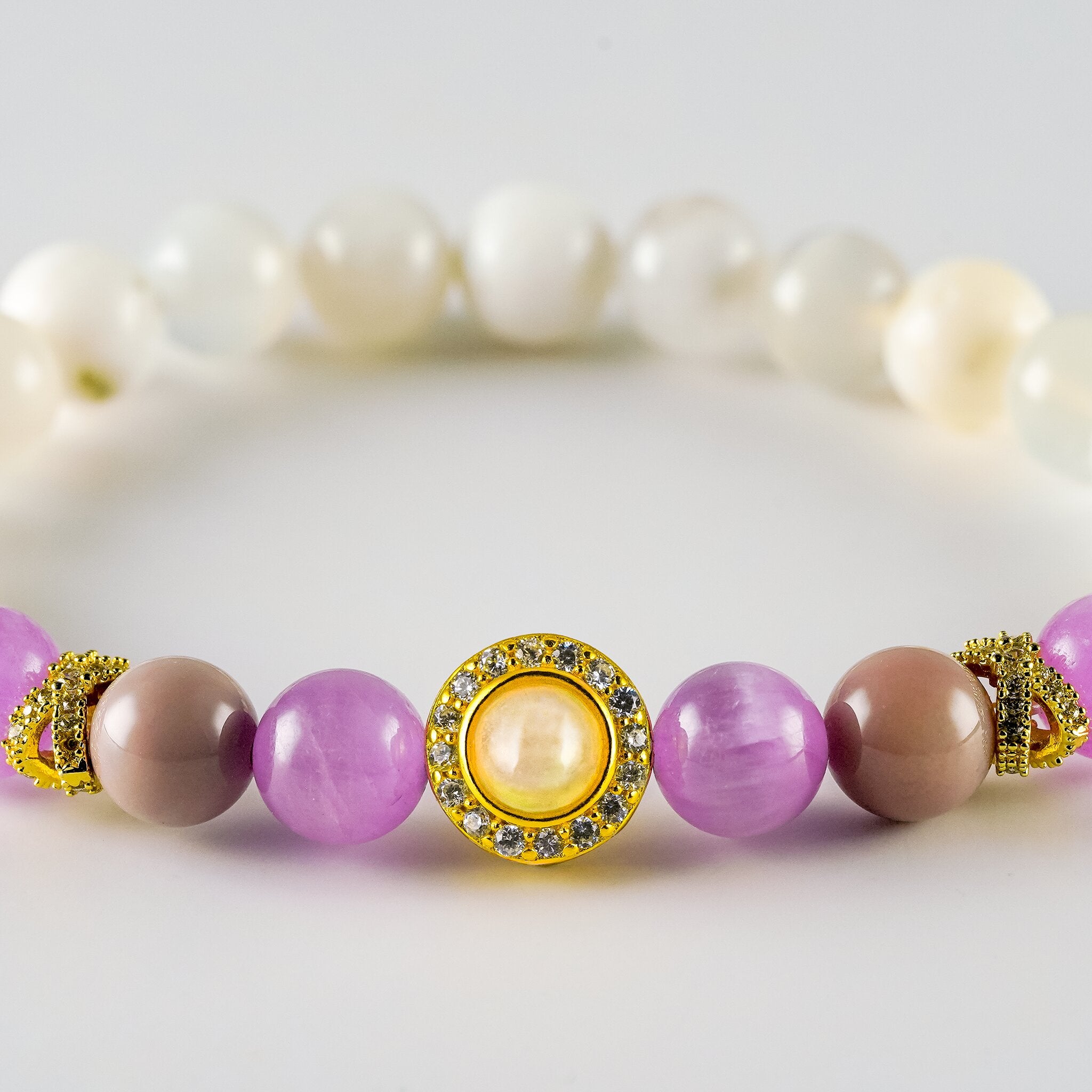 Opal Oracle Collection Isis Enchantment bracelet by XOIAX, close-up crop showing Cat's Eye Kunzite beads and gold-plated Opal medallion charm