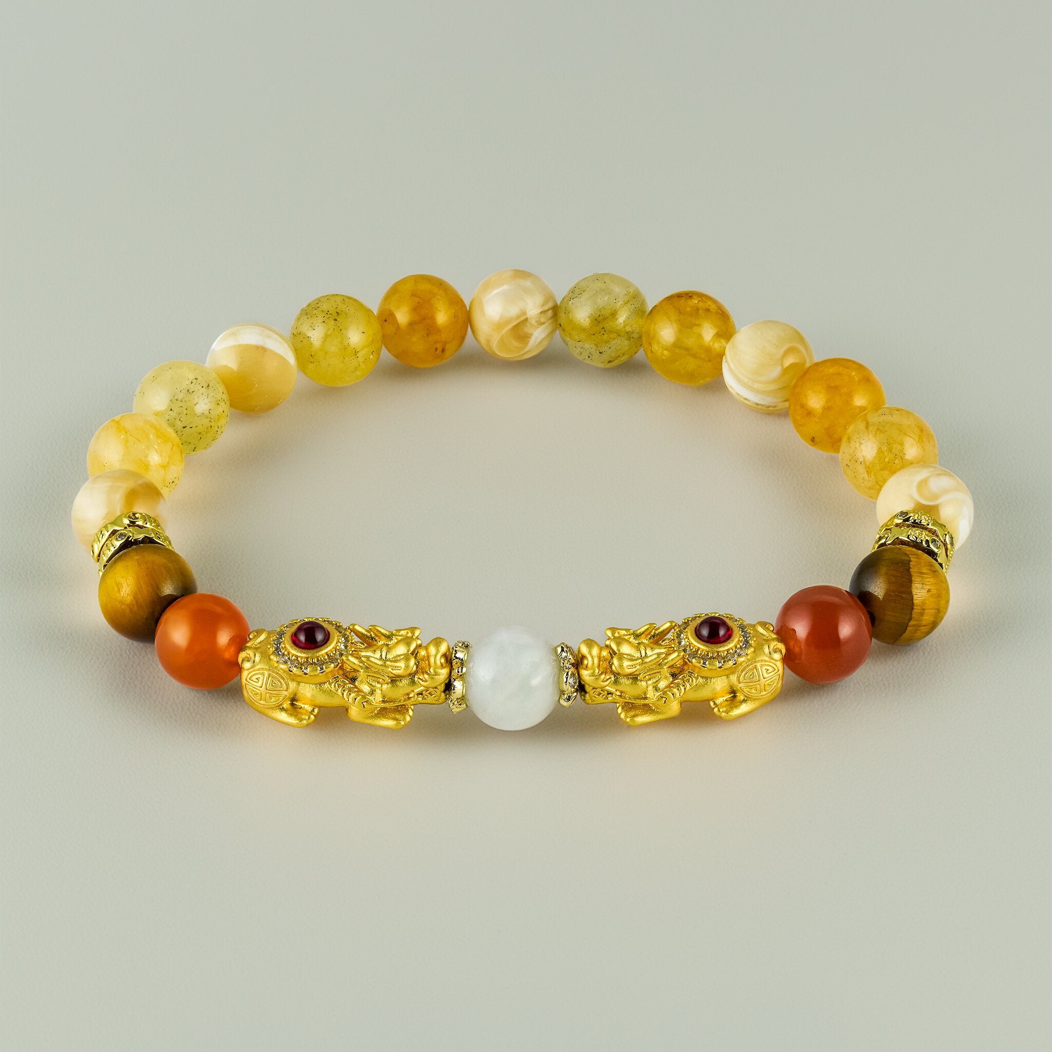 Secret Guardians Twin Jewelled Pixius Ruby Moon bracelet by XOIAX with Orange Carnelian, Brown Tiger Eye, and Natural Beige Tridacna beads with gold dragon charms