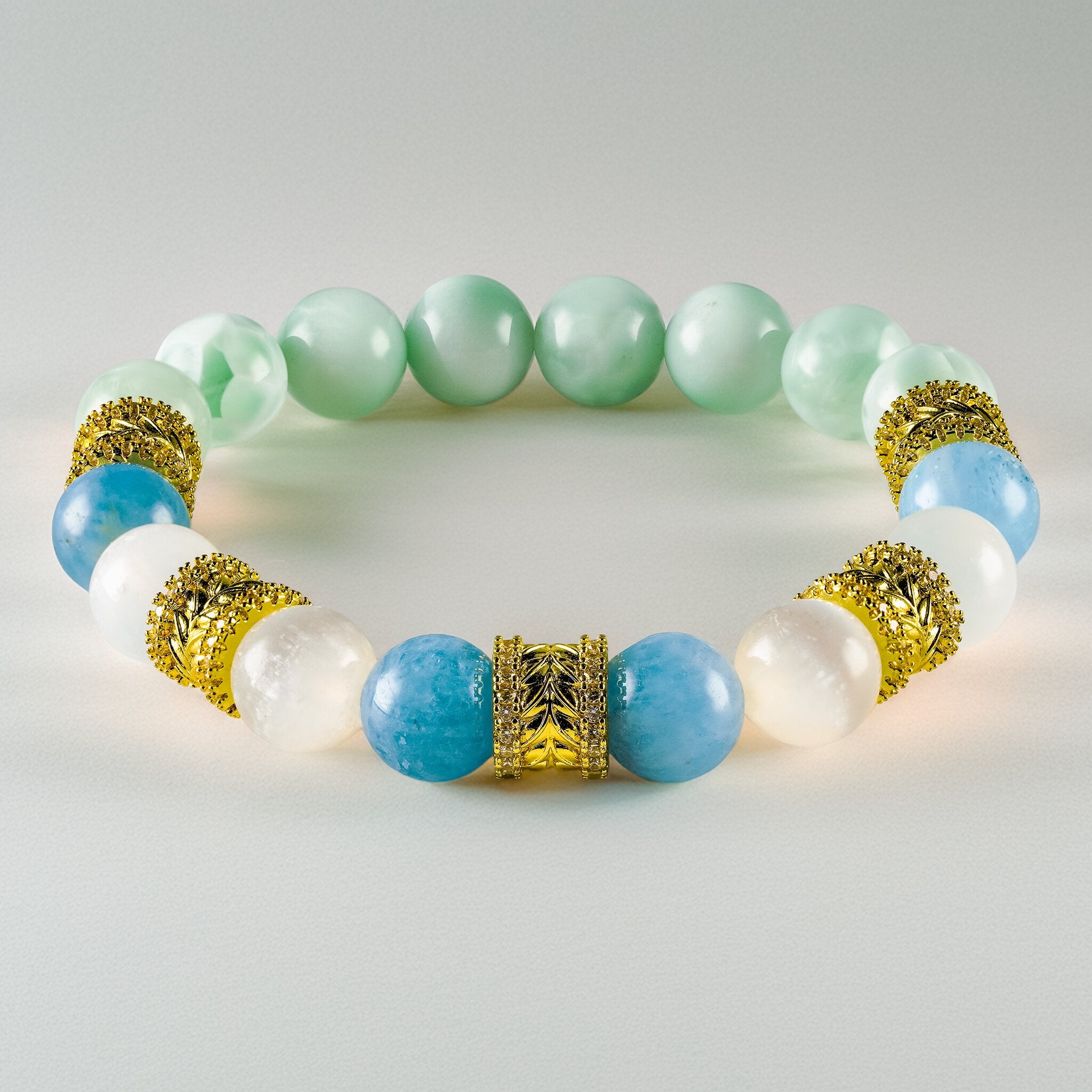 XOIAX Golden Wreaths The Azure Halo feng shui bracelet featuring Aquamarine, Selenite, and Green Larimar beads with 18k gold plated wreath spacers